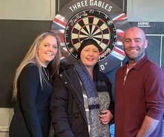 Cancer survivor staging charity darts event
